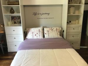 a bedroom with a bed with a sign that reads life is a journey at Quiet Cozy Luxury on the Thames in Ontario! in London