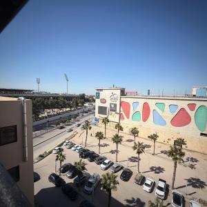 a parking lot with cars parked in front of a building at ريڨا للأجنحة السكنية Riva suites in Irbid