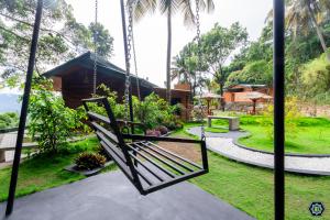 a swing in the garden of a house at Hotel Narangala Wooden Villa in Badulla