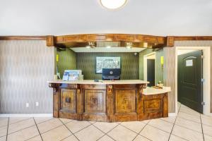 an office with a desk with a laptop on top of it at Super 8 by Wyndham Jackson MS Near the Fairgrounds in Jackson +57 photos