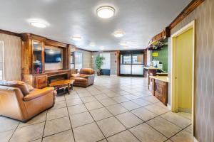 a large living room with a couch and a table at Super 8 by Wyndham Jackson MS Near the Fairgrounds in Jackson