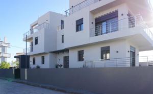 a white house with balconies on the side of it at H residence 2 in Artemida
