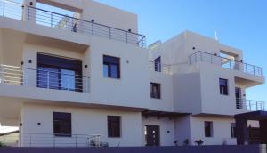 a white building with balconies on the side of it at H residence 2 in Artemida