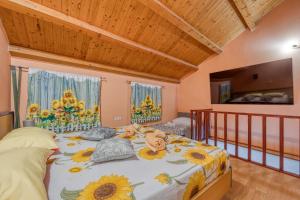 a bedroom with a large bed with flowers on it at App Bonić in Veli Lošinj