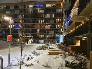 a building with snow on the ground in front of it at Ulven Paradise in Oslo