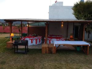 a tent with red and white tables and chairs at Casa en Xochimilco in Mexico City