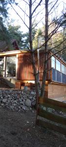 a wooden house with a bench in front of it at Dom Parlinek agroturtstyka wędkowanie sauna jacuzzi in Dąbrowa