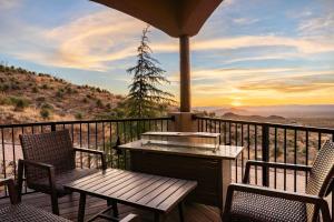 a porch with two chairs and a table and a table and two chairs at Secluded Retreat Pool Spa Sauna Rooftop Deck in Las Cruces