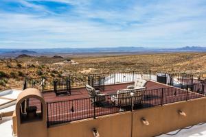 a balcony with chairs and a view of the desert at Secluded Retreat Pool Spa Sauna Rooftop Deck in Las Cruces