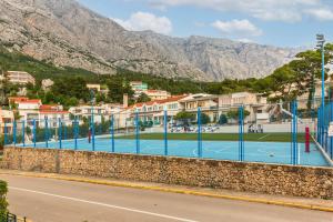 a tennis court on a wall next to a city at Luxury Villa MAJA in Baška Voda