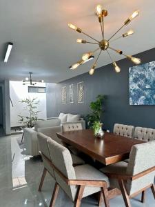 a dining room with a wooden table and chairs at AR SUITES Casa Luneta in Zamora de Hidalgo