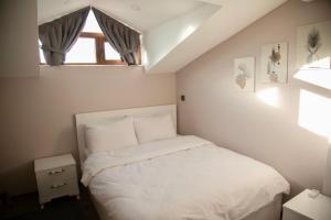 a bedroom with a white bed and a window at Sofia Beach Residence in Trabzon