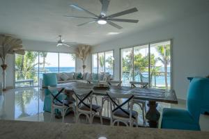 a dining room with a table and chairs and a couch at Sea Winds Cabarete in Cabarete