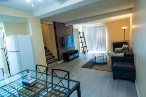 a living room with a couch and a table at Charming 2-Bedroom House in Central Calgary in Calgary