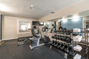 a gym with treadmills and weights in a room at The Branson Waterpark Hotel in Branson