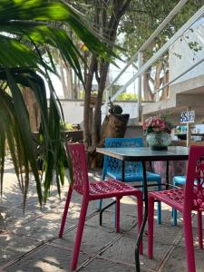 a table and four chairs and a table and a table and chairs at Margaritas Eco Haus in Querétaro