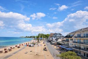 a view of a beach with buildings and the ocean at Ostsee Suite 2 - Penthouse in Niendorf
