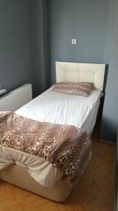 a bedroom with a bed with a leopard print sheets at Huzur10 in Edirne