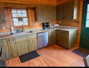 a kitchen with wooden cabinets and a sink in a cabin at Haven View Retreat in White Haven +31 photos