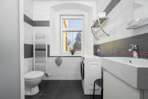 a white bathroom with a toilet and a sink at Penzion, restaurant Gloria in Chrastava +64 photos