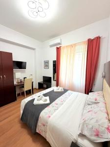 a hotel room with a bed and a desk and a room at MBS Marconi Bridge Suites Guest House in Rome