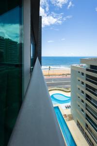 a view of the beach from the balcony of a building at Art studio open space in Água Boa