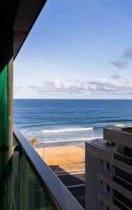 a view of the ocean from a building at Art studio open space in Água Boa