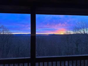 a view of a sunset from a house window at Haven View Retreat in White Haven