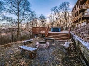 a group of benches and a fire pit in a yard at Haven View Retreat in White Haven