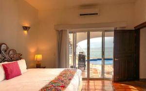 a bedroom with a bed and a view of the ocean at Ocean Front Villa - Private Pool and Ocean Access in Puerto Vallarta