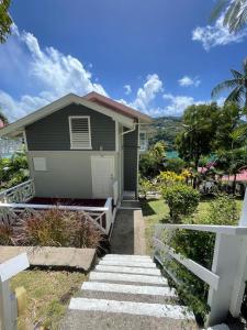a house with a white fence in front of it at Oasis Marigot Bay in Marigot +7 photos