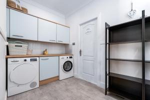 a white laundry room with a washer and dryer at Casa Lorna in Marbella
