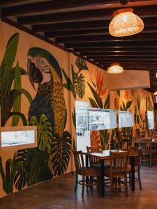 a mural of a parrot on the wall of a restaurant at Antara Resort in Alcalá