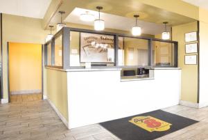a bar in a restaurant with a counter and a rug at Super 8 by Wyndham Indianapolis South in Indianapolis