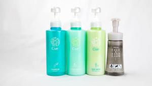 a group of four bottles of shampoo and conditioner at Hotel Route-Inn Aomori Ekimae in Aomori