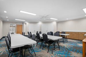 a conference room with tables and chairs and a whiteboard at Days Inn by Wyndham Imlay City in Imlay City +28 photos