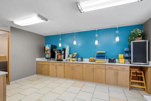 a large kitchen with a blue wall at Days Inn by Wyndham Imlay City in Imlay City
