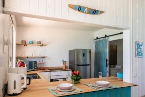 a kitchen with a table with two bowls on it at Matira Lagoon in Bora Bora