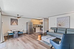 a living room with a couch and a table at Interurban Suites Hotel, a Dazzler Select by Wyndham in Tukwila