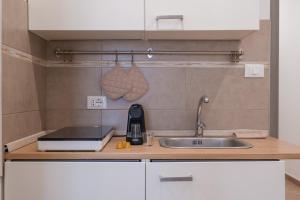 a kitchen counter top with a sink and a sink at Rooms 2Binari in Bologna