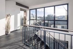 a balcony with a view of a city at Ostsee Suite 1 - Strandperle in Niendorf +11 photos