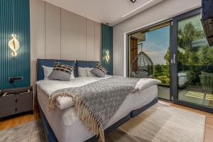 a bedroom with a bed and a large window at Luxury Villa Elements - Novalja in Novalja +47 photos