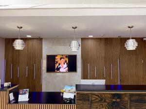 an office with a desk and a tv on the wall at Days Inn & Suites by Wyndham Morris I-80 in Morris +36 photos