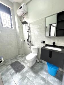 a bathroom with a white toilet and a sink at Aimarck Homes and Suites in Kampala