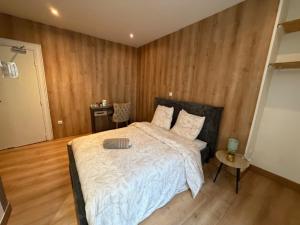 a bedroom with a large bed and a wooden floor at Hôtel Le Normandie in Le Mans +3 photos