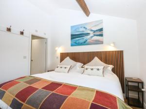 a bedroom with a large white bed with pillows at The Studio in Caernarfon