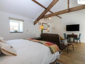 a bedroom with a large bed and a living room at The Studio in Caernarfon