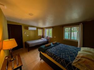 a bedroom with a bed and a table and a window at B&B Del Lago in Flores