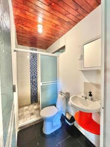 a bathroom with a toilet and a sink at Manigua Tayrona Hostel in Santa Marta +80 photos