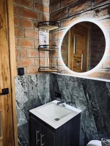 a bathroom with a sink and a mirror at Relajate en una TinyHouse privada en Baños de Agua Santa con Jacuzzi y vistas increíbles in Baños